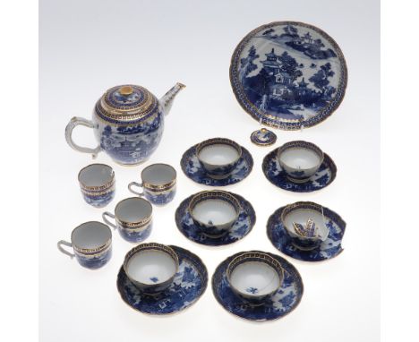 A Chinese porcelain tea service decorated in blue with pagodas and figures in a landscape, with gilt decorated borders and fo