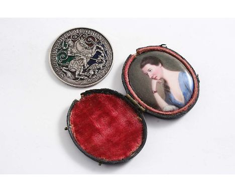 A 19TH CENTURY ENAMELLED COPPER MINIATURE PORTRAIT OF A YOUNG LADY wearing a lace-trimmed blue dress (in a fitted shagreen ca