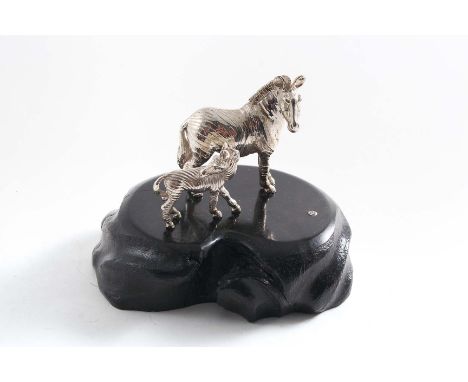 A CONTEMPORARY SOUTH AFRICAN MINIATURE SCULPTED FIGURE GROUP OF A ZEBRA AND FOAL on an ebony base by Patrick Mavros of Zimbab