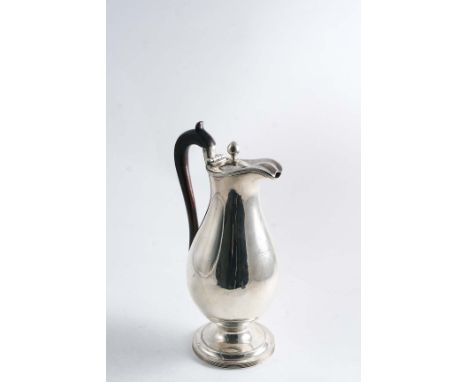 A GEORGE III BALUSTER HOT WATER JUG  on a circular pedestal foot with reeded borders & a bud finial, crested, by Edward Ferne
