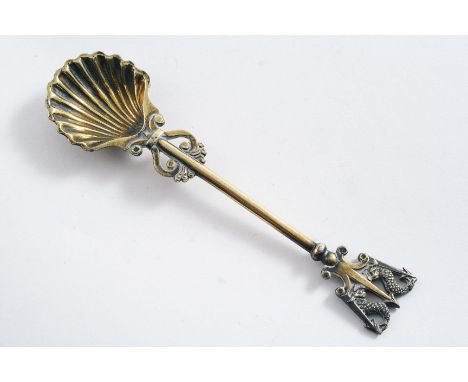 BY PAUL STORR:- A George III silvergilt saltspoon with a scallop-shell bowl and a trident terminal with dolphins, London 1813