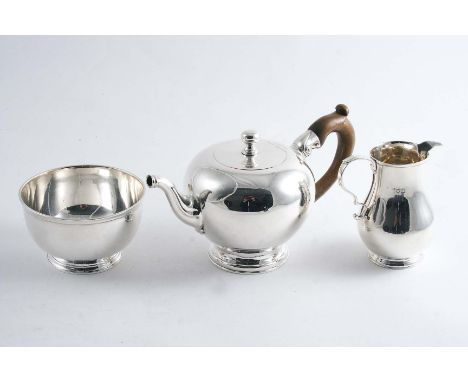 A SMALL BULLET TEA POT in the early George II style on a circular foot with a flush hinge & a knop finial together with  a ma