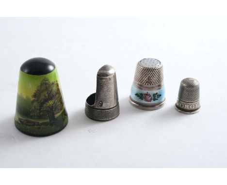 A LATE VICTORIAN CHILD'S THIMBLE stamped "FORGET ME NOT", unmarked, a George III "finger guard" thimble, maker's mark only, b