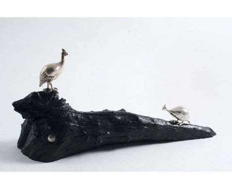 A CONTEMPORARY SOUTH AFRICAN MINIATURE SCULPTED GROUP OF TWO GUINEA FOWL on an ebony base, by Patrick Mavros of Zimbabwe, c.1