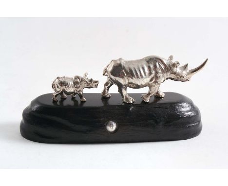 A CONTEMPORARY SOUTH AFRICAN MINIATURE SCULPTED FIGURE OF A RHINO LEADING ITS CALF, by Patrick Mavros of Zimbabwe, c.1980 (ha