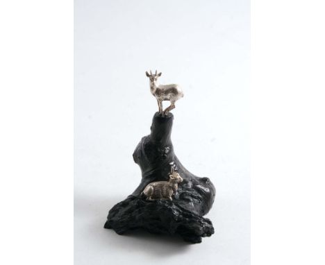 A CONTEMPORARY SOUTH AFRICAN MINIATURE SCULPTED GROUP OF TWO MOUNTAIN GOATS on a carved ebony base, by Patrick Mavros of Zimb