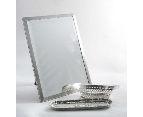 A RECTANGULAR MIRROR FRAME with an engine-turned border, bevelled glass & wooden easel back, maker's mark "E.M.LTD", Birmingh