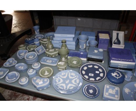 A quantity of Wedgwood Jasperware, largely in shades of blue, to include lidded trinket boxes, vases, and boxed commemorative