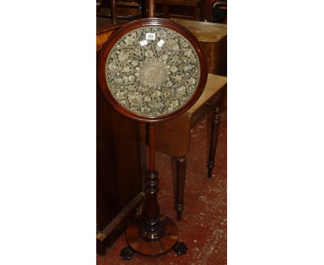 A Victorian mahogany pole screen with a circular tapestry panel, on a circular base with carved paw feet, 150cm high 