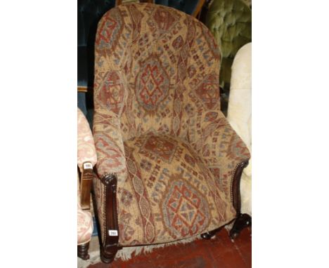 An upholstered button back tub armchair, late 19th century  