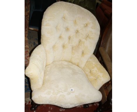 A Victorian upholstered button back armchair  