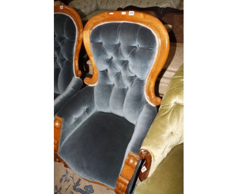 A Victorian mahogany framed button back easy chair on turned supports 