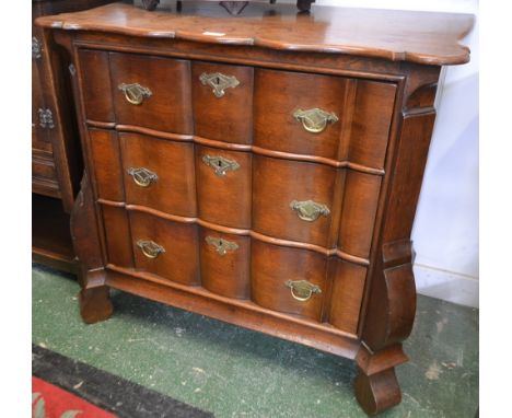 A 19th century Dutch oak shaped serpentine commode, of small proportions, three long graduated drawers, 80cm high, 86cm wide