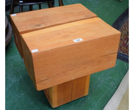 A contemporary stool, composed of three substantial oak posts, 46cm high