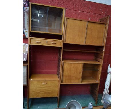 A mid-20th century teak bookcase/display cabinet, the superstructure comprising three independent ladder sections supporting 