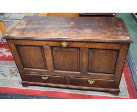 A late 18th/early 19th century oak blanket chest, moulded hinged rectangular top above a three panel fall front enclosing a p