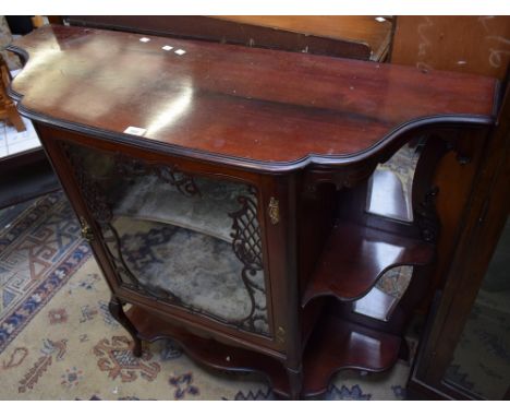 An early 20th century mahogany side cabinet, moulded top above a central door enclosing an incurve shelf, flanked by a pair o