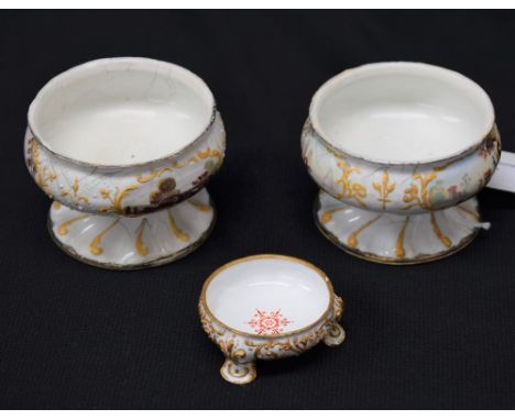 A pair of South Staffordshire enamel pedestal salts, enamelled with rural scenes within raised scroll cartouches, spiralled b