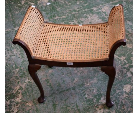 A 20th century mahogany framed stool, scroll end supports, woven cane seat, cabriole legs, pad feet, 64cm wide