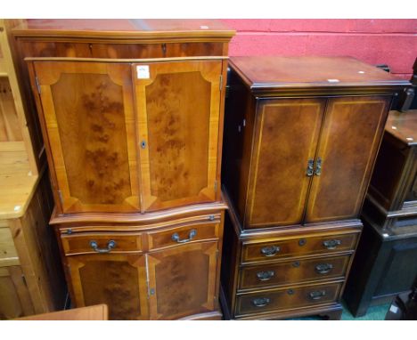 A reproduction 'walnut' side cabinet, serpentine top above a pair of doors enclosing an adjustable shelf, a slide, one long d