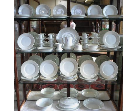 A Limoges plain white porcelain dinner service, for twelve, comprising dinner plates, salad plates, dessert bowls, sauce boat