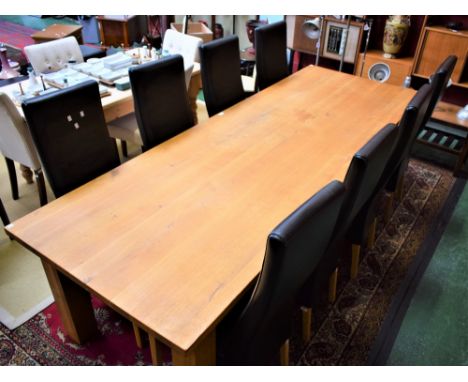 A contemporary light oak dining table, slightly rounded rectangular top, substantial square legs, 280cm long; a set of eight 