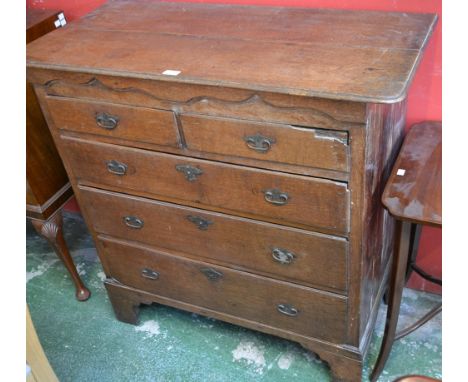An unusual George II Provincial Gothic oak chest of drawers, idiosyncratic oversailing top above an ogee arched frieze and tw