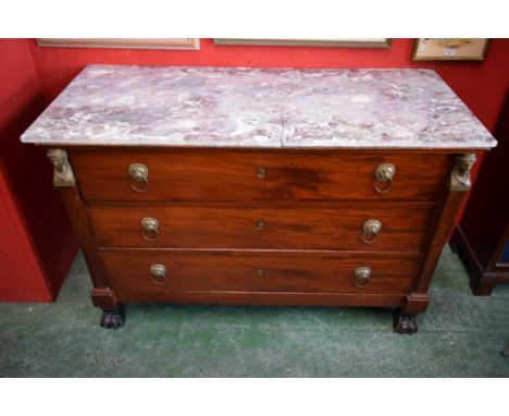 A French Empire mahogany commode, in the manner of Bernard Molitor, rectangular marble top above three long drawers flanked b