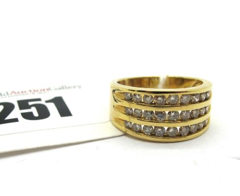 A Modern Diamond Set Dress Ring, three row channel set throughout with brilliant cut stones, stamped "18K". *Stanley Hunt Jew