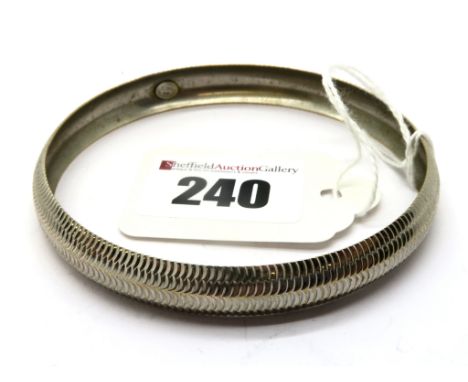 A Modern Bangle, of textured design, stamped "375". 