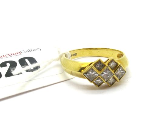 A Modern 18ct Gold Princess Cut Diamond Set Ring, collet rubover graduated offset, between plain shoulders.