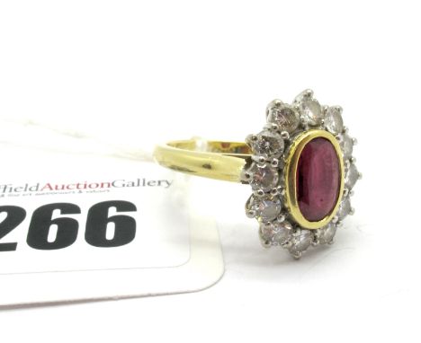 An 18ct Gold Ruby and Diamond Cluster Ring, oval collet rubover set to the centre, within border of brilliant cut diamonds. 