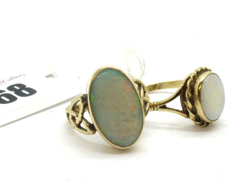 A Modern 9ct Gold Opal Set Ring, elongated oval cabochon collet set to the centre (closed back), between openwork shoulders; 