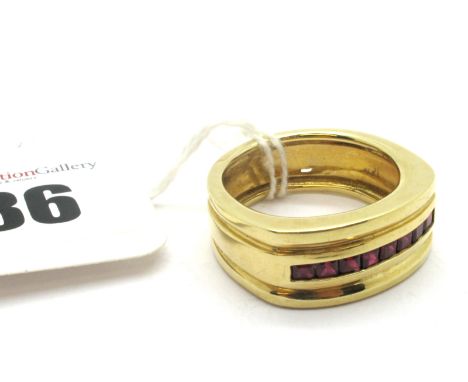 A Ruby Set Dress Ring, of wide three row design, channel set to the centre with uniform stones, indistinctly stamped "14k". 