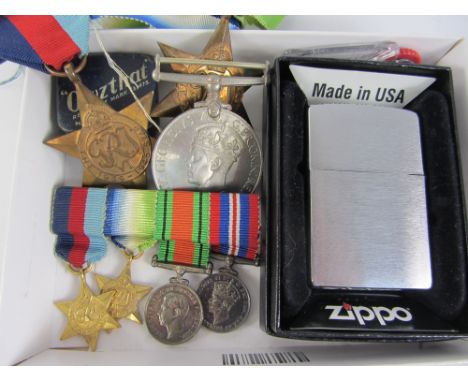 Group of three WWII medals including The Atlantic Star and a group of four matching miniatures, Zippo lighter, 'Owzhat' crick