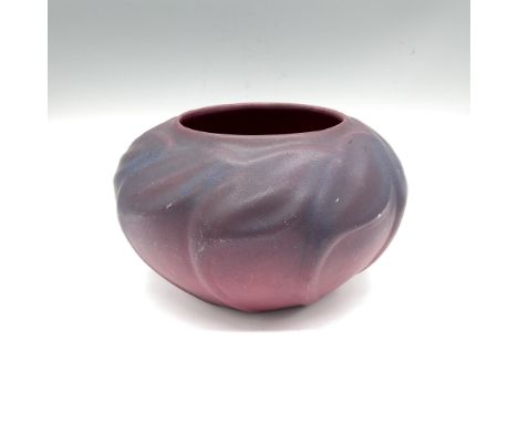 A small round vase in shades of dark purple, decorated with raised stylized foliate pattern. Van Briggle U.S.A. carved markin