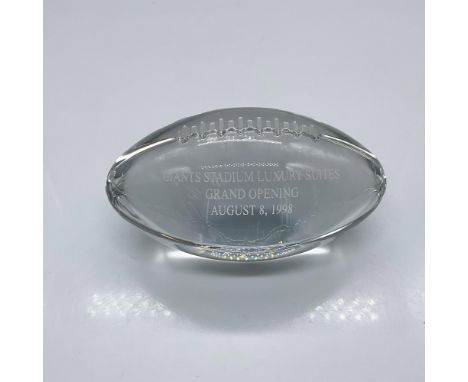 A clear American football shaped desk decor. Giants Stadium Luxury Suites Grand Opening August 8, 1998 engraved on the side. 