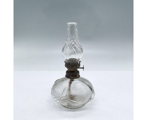 Clear and textured glass oil lamp with ribboned sash design on the body. Includes chimney. Dimensions: 6.5"H x 3.75" diaCondi