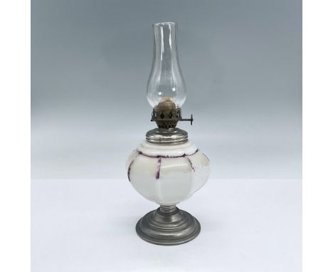 Oil lamp with clear glass chimney, white milk glass body, silvertone metal and bronze hardware. Dimensions: 9"H x 3.5" diaCon