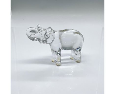 A clear figure of an elephant with the trunk raised up and curled towards the head. Baccarat acid-etched marking. Dimensions: