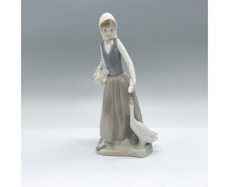 Glossy figure of a young girl feeding vegetables to a happy goose. Nao backstamp. Dimensions: 5"L x 4.5"W x 9.5"HManufacturer