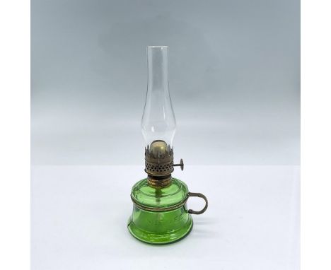 Small green glass oil lamp body and clear chimney with bronze colored hardware. Nutmeg embossed to body. Dimensions: 3.5"L x 