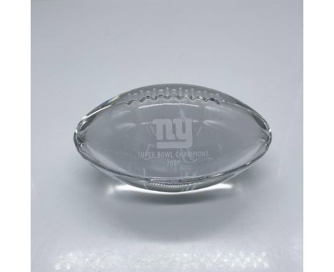 A clear American football shaped desk decor. NY Super Bowl Champions 2007 engraved on the side. Tiffany &amp; Co. stickered a