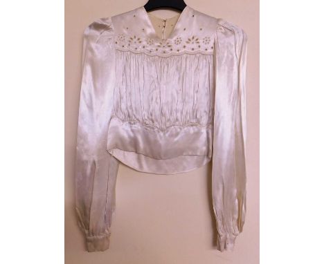A 1930-40's cream satin blouse, V-neck with cutwork detail to front and back, with gathered body, tapered hem and long sleeve