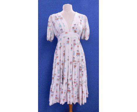 A 1960's Ossie Clarke for Radley floral print dress, the cream dress with red, blue, green and black floral print, V-neck wit