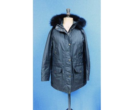 A lady's black Belstaff hooded parka, zip fronted with storm flap and popper fastening, front patch and side pockets, quilted