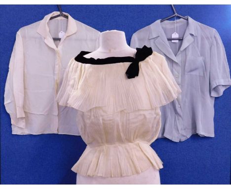 Three mid 20th century lady's blouses, to include a cream silk blouse, a pale blue silk blouse with breast pockets and pintuc