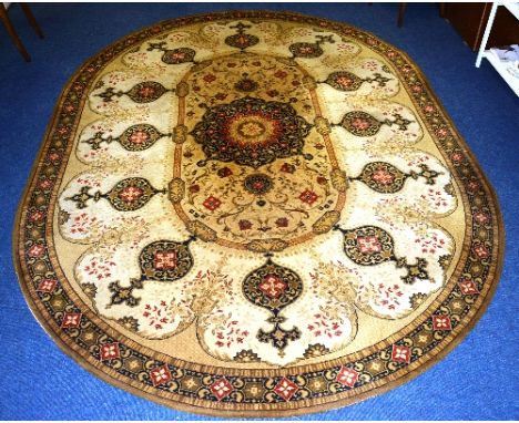 An oval carpet of Eastern design, with central navy flower head motif on cream ground, with allover foliate decoration in nav