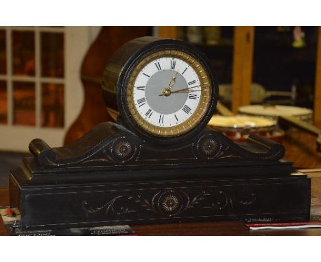 A Victorian black slate mantel clock, the drum shaped top with white enamel chapter ring and Roman numerals, converted to ele