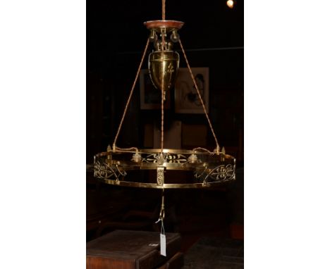 A brass rise and fall ceiling light circa early 20th century, with three light sconces, brass coated lead filled weight and p